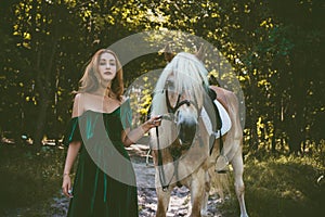 Woman with a horse at forest, mystical scene