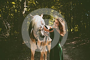 Woman with a horse at forest, mystical scene