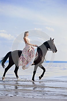 Woman on a horse by the sea