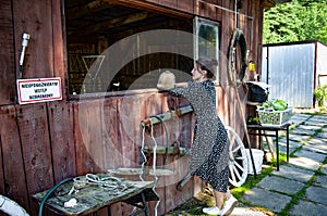 Woman at horse stable in countryside ranch. Girl horse rider in summer outdoor. Equestrian and horseback riding. Horse stable with