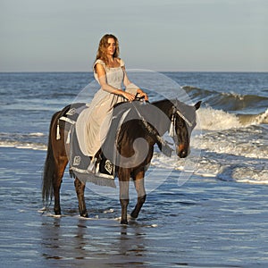 Woman on horseback in ocean