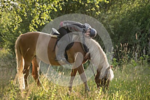 Woman horseback riding in sunset