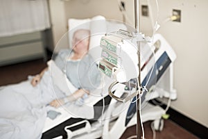 Woman in hospital bed suffering from cancer