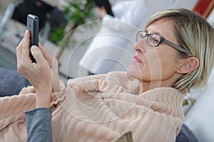 Woman in hospital waiting room using phone