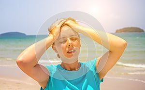 Woman on hot beach with sunstroke. Health problem on holiday. Medicine on vacation.