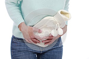 Woman with hot bottle and stomach pain