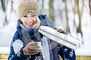 Woman with hot tea or coffee on a winter hike