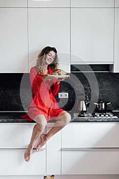 woman housewife cooks roast duck in the oven in the kitchen