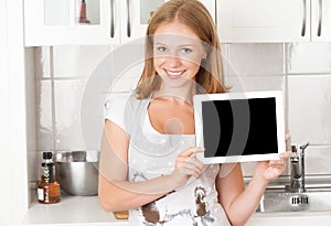 Woman housewife in the kitchen with an blank empty tablet computer