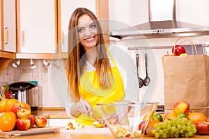 Woman housewife in kitchen cutting apple fruits