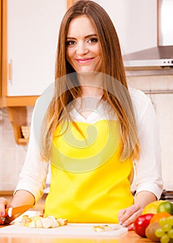 Woman housewife in kitchen cutting apple fruits