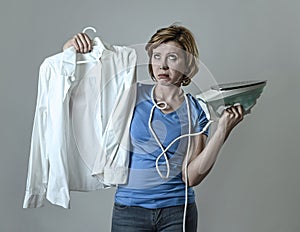 Woman or housewife sad bored and stressed holding white shirt an