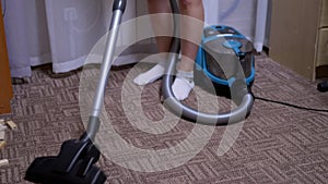 Woman, Housewife Vacuums Brown Carpet at Home. Cleaning, Order in Room. 4K