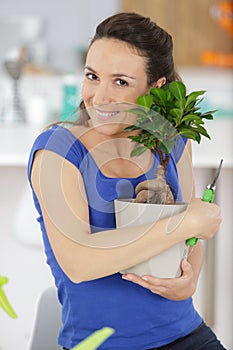 Woman hugging bonsai