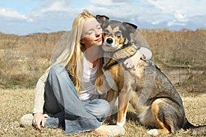 Woman Hugging German Shepherd Dog Outside