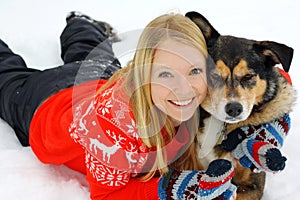 Woman Hugging German Shepherd Dog in Snow