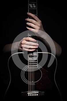 Woman Hugging With Guitar, Isolated On Black