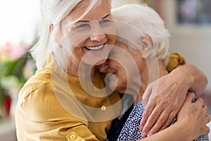 Woman hugging her elderly mother