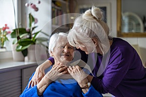 Woman hugging her elderly mother