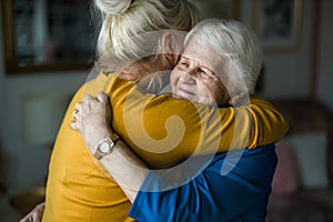 Woman hugging her elderly mother