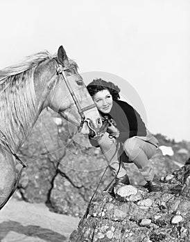 Woman hugging her horse