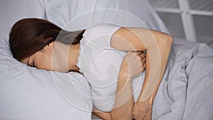 woman hugging herself while lying on