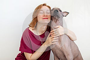 A woman hugging with a Mexican Hairless Dog