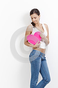 woman hugging paper heart smiling