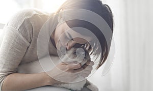 Woman hugging and petting her cat