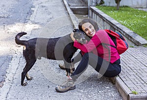 Woman hugging a sad stray dog