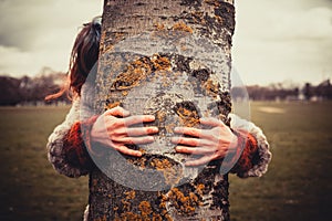 Woman hugging a tree