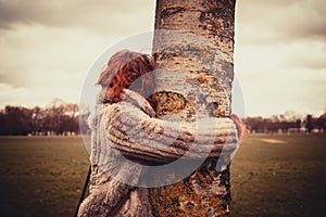 Woman hugging a tree