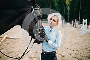 Woman hugs her horse, friendship, horseback riding