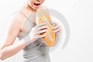 Woman hungry fresh fragrant bread.