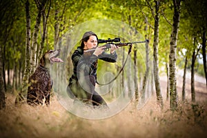 Woman hunter in the woods photo