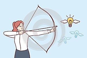 Woman hunting for new ideas, holding bow and arrow and aiming at flying light bulb to achieve goals
