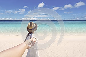 Woman with husband running on the beach