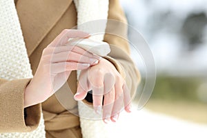 Woman hydrating hands with moisturizer cream