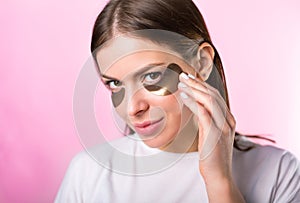 Woman with hydrogel eye patches