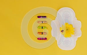 Woman hygienic protection, menstruation, cotton swabs, sanitary pads on a yellow background. critical days. Copy space