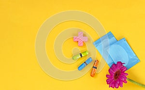 Woman hygienic protection, menstruation, cotton swabs, sanitary pads on a yellow background. critical days. Copy space