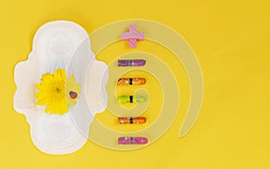 Woman hygienic protection, menstruation, cotton tampons, sanitary pads on a yellow background. critical days. Copy space