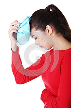 Woman with ice bag for headaches and migraines