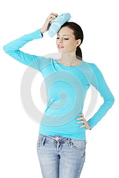 Woman with ice bag for headaches and migraines
