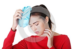 Woman with ice bag for headaches and migraines