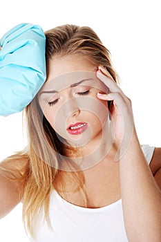 Woman with ice bag heaving headache