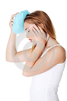 Woman with ice bag heaving headache