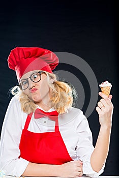 Woman with ice cream homemade grimaces on black
