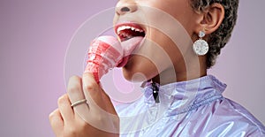 Woman, ice cream and mouth while eating pink dessert with cone against studio background. Model, zoom and lick sorbet