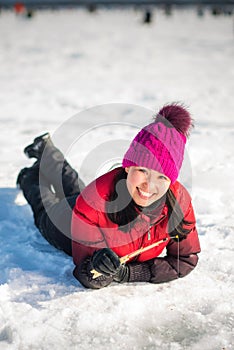 Woman ice-fishing in the winter